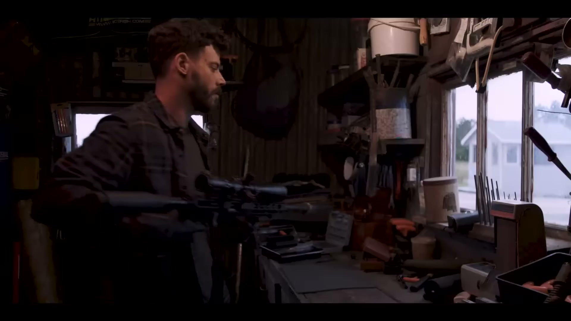 The Sniper cleaning his rifle in the workshop
