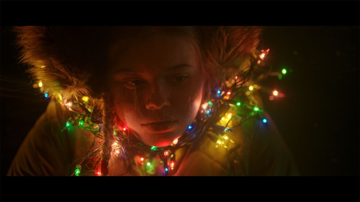 Maggie wrapped in Christmas lights